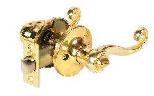 Polished brass door handle with lock mechanism on a white background.