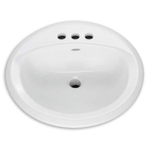 White oval bathroom sink with three faucet holes on a plain background.