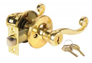 A shiny gold door handle with lock and keys isolated on a white background.