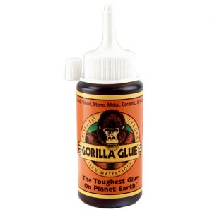 A bottle of Gorilla Glue with its logo and text claiming it's the toughest glue on Earth.