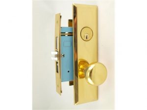 Gold doorknob and lock set against a white background.