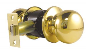 A shiny gold-colored doorknob with latch and keyhole on a white background.