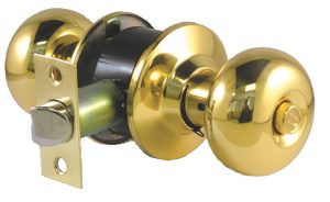 A gold-colored doorknob set with a keyhole and lock mechanism isolated on a white background.