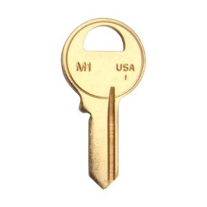 Brass key with "M1 USA" inscription isolated on a white background.