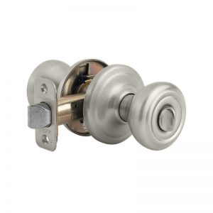 A satin nickel door knob with a lock on a white background.