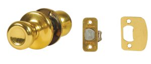 Gold-colored doorknob with lock mechanism and matching metal strike plates.