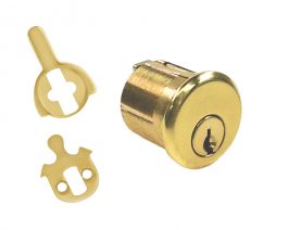 A brass cylinder lock and keys on a white background.