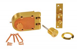 Disassembled brass padlock parts with key, shackle, and screws on a white background.
