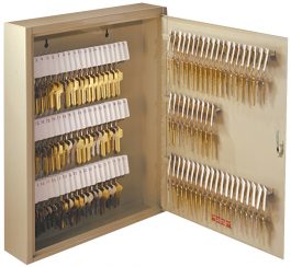 An open wall-mounted key storage cabinet with labeled rows of keys.