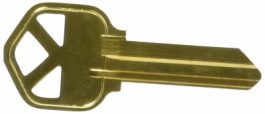 A single brass key isolated on a white background.