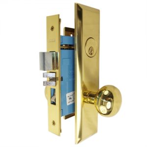 Gold-colored door lock hardware with deadbolt, latch, and keyhole on white background.