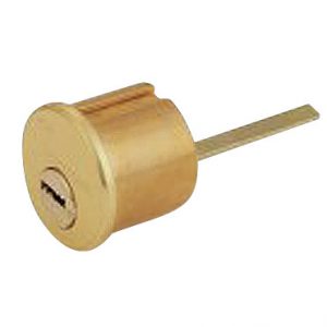 A brass cylinder lock core with a single key slot on a white background.