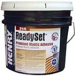 Container of Henry ReadySet premixed mastic adhesive with branding and product information on the label.