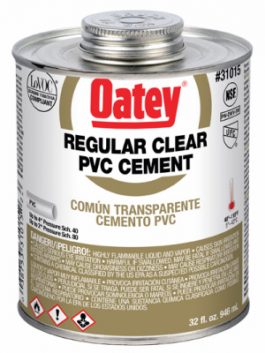 A can of Oatey regular clear PVC cement with warning labels and product details.