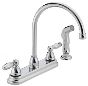 Chrome kitchen faucet with two handles and a separate side sprayer on a white background.