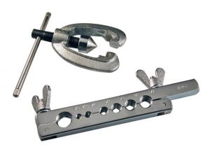 A tap and die set for threading and cutting metal surfaces isolated on a white background.