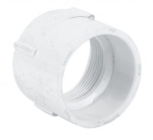 White PVC pipe connector with threaded interior on a white background.