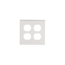 A white quadruple electrical outlet wall plate isolated on a white background.