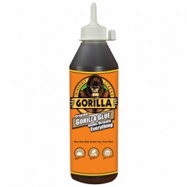 A bottle of Gorilla Glue adhesive with a gorilla logo and text claiming to bond various materials.