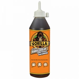 A bottle of Gorilla Glue adhesive with a gorilla logo and text claiming to bond various materials.