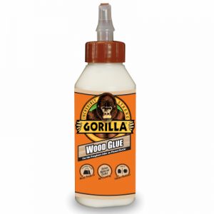 Bottle of Gorilla Wood Glue with orange label and black cap on white background.