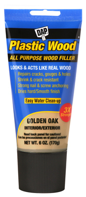 A tube of DAP Plastic Wood All Purpose Wood Filler in Golden Oak color.