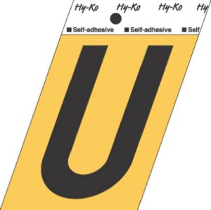 A black letter 'U' on a yellow self-adhesive label.