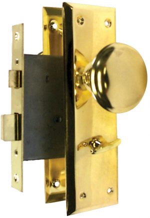 A shiny brass doorknob on a latch assembly with a black lock mechanism.