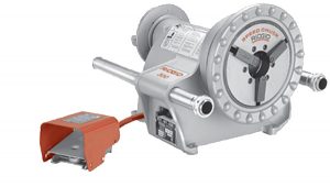 Industrial bench grinder with a red push-button switch.