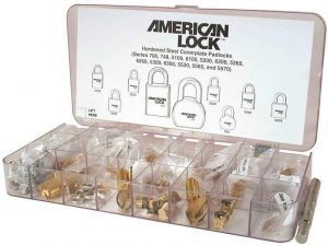 Organizer box with various lock parts labeled "AMERICAN LOCK" and lock diagrams on lid.