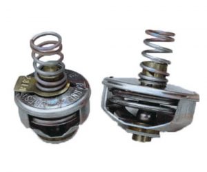 Two thermostat valves for a vehicle, one intact and the other disassembled, isolated on a white background.