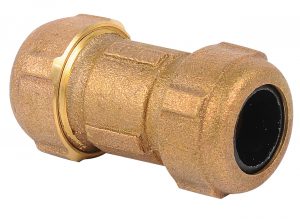 Brass compression fitting for plumbing isolated on a white background.