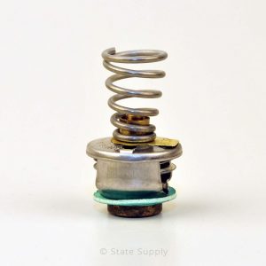 Close-up of a metal thermostat with a coiled spring, against a white background.