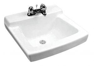 White wall-mounted ceramic sink with two metal faucets on a plain background.