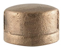 A close-up of a cylindrical, bronze-colored metal object with a textured surface.