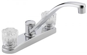 Chrome double-handle kitchen faucet against a white background.