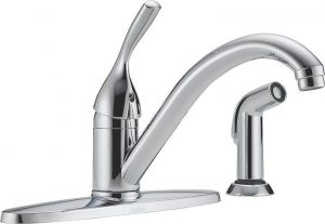 Chrome kitchen faucet with single handle and separate sprayer on white background.