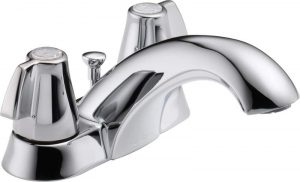Shiny chrome bathroom faucet with dual handles on a white background.