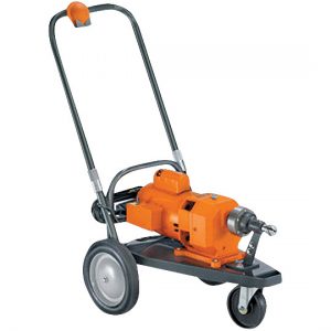 Orange portable railroad track drill machine on a two-wheel cart.