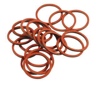 A pile of scattered red rubber bands on a white background.