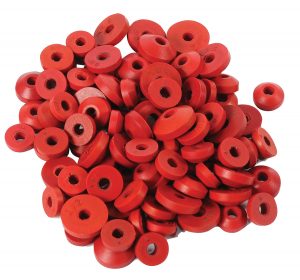 A pile of red rubber stoppers with various sizes and numbers stamped on them.