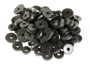 Heap of assorted black metal washers on a white background.