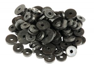 A pile of various sized black metal washers on a white background.