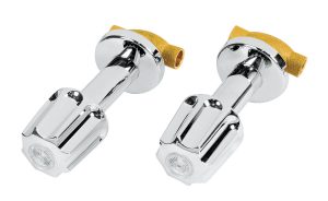 Two chrome shower faucets with yellow tape on white background.