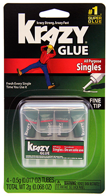 Packaging for Krazy Glue singles with fine tip, featuring four small tubes on a hanging card.