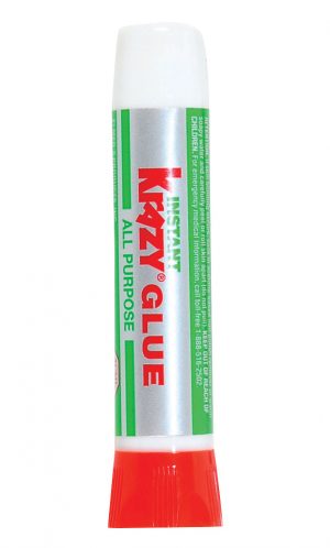 Tube of adhesive with a red cap and green label on a white background.