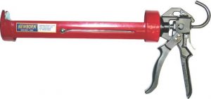 A red caulk gun, model 135, by Newborn, against a white background.
