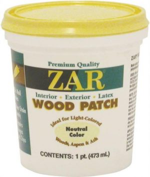Container of ZAR wood patch putty in a yellow lidded white tub.