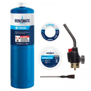 Propane gas cylinder, solder wire spool, torch head, and flux brush for plumbing.