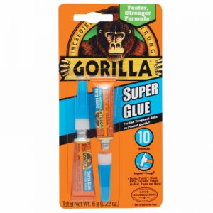 Packaging of Gorilla Super Glue with blue and orange tubes on an orange background.